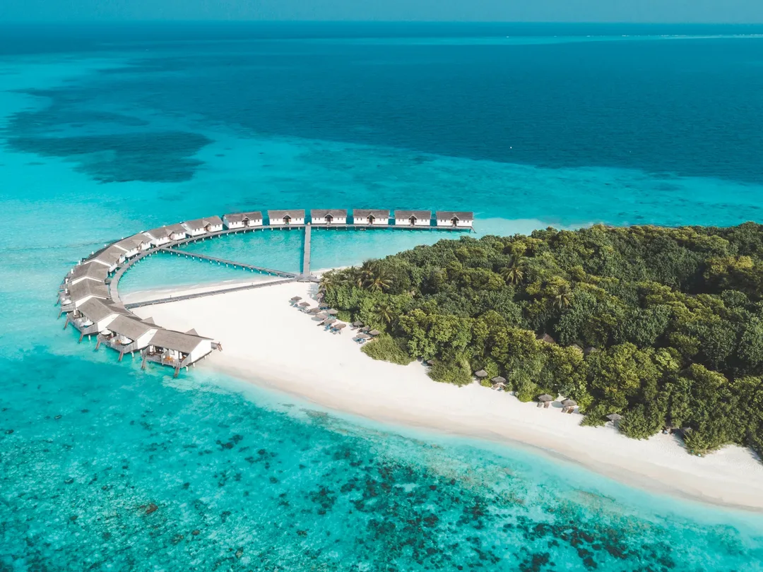 Overwater villas and beach at NH Collection Maldives Reethi Resort