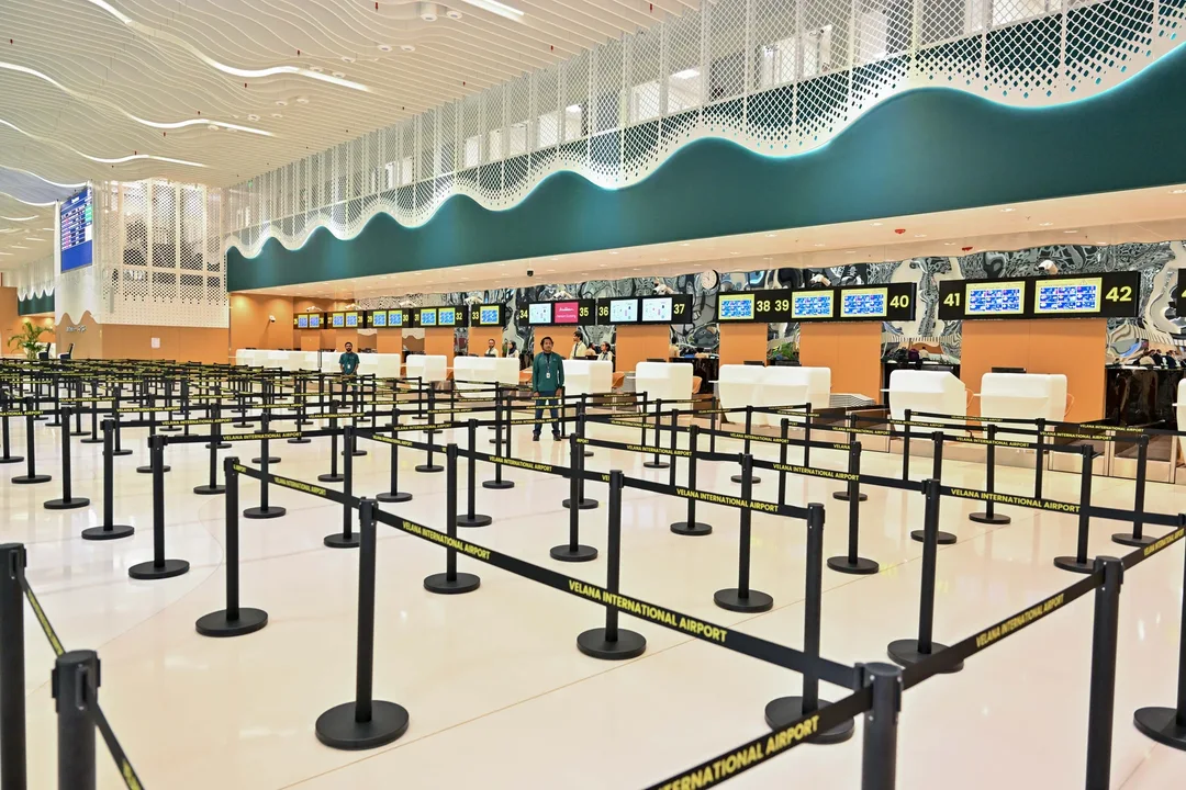 Rows of empty queue barriers in front of the check-in counters in the new terminal at Velana International Airport.